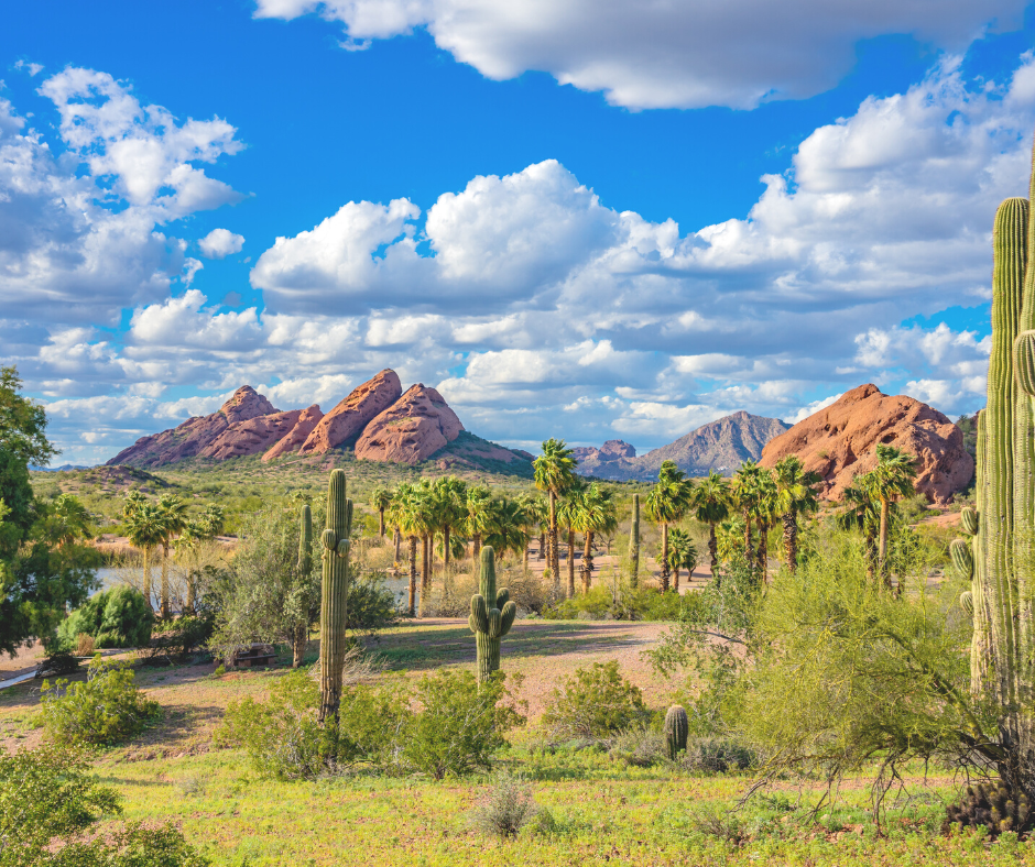 View of Phoenix landscape with Papago Park in the back. The sky is partly cloudy.