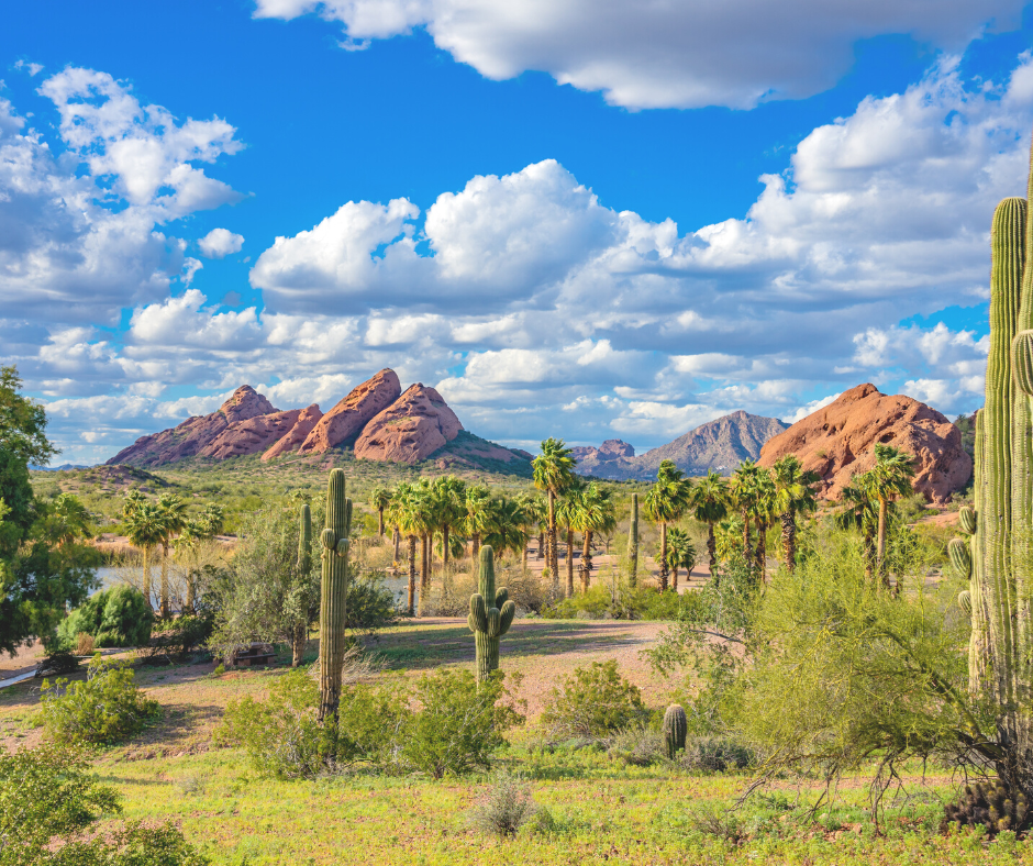 View of Phoenix landscape with Papago Park in the back.  The sky is partly cloudy.
